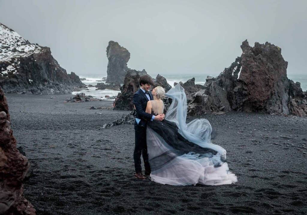 A wedding photoshoot at a black sand beach in Iceland