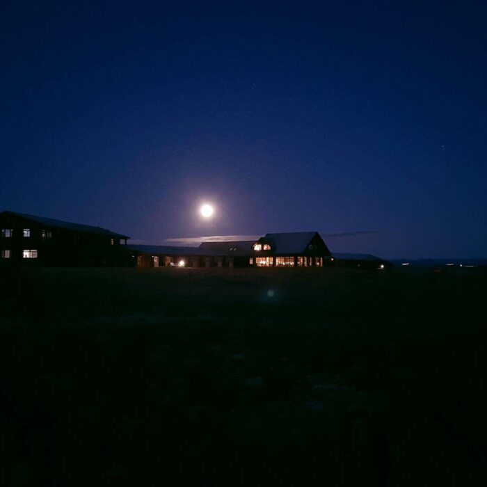 Exterior of Hotel Rangá at nighttime underneath the moon.