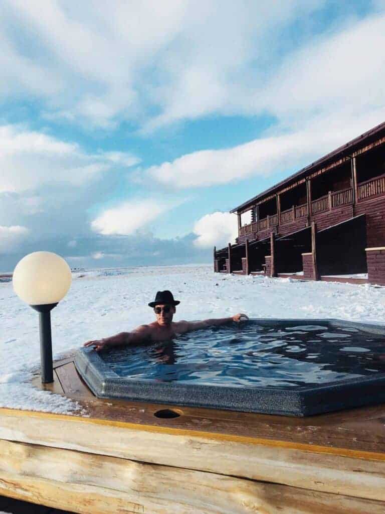 A man in the hotel Rangá geothermal hot tubs.