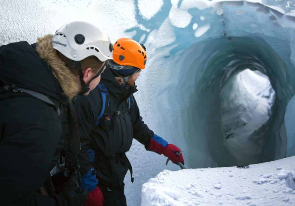 Two people glacier climbing in Iceland