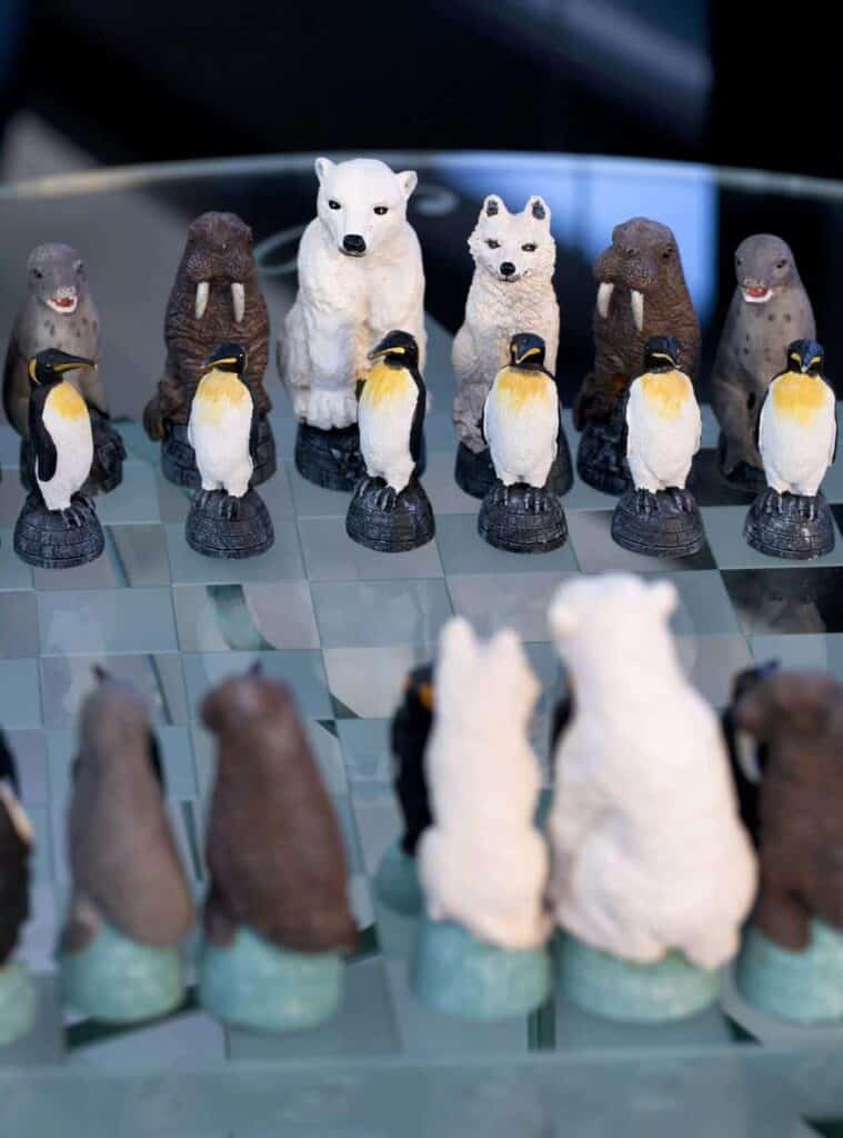 A glass chessboard with penguins and bears.