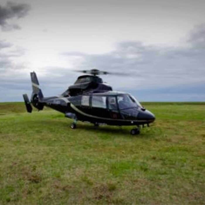 Helicopter parked on a grassy field in south Iceland.