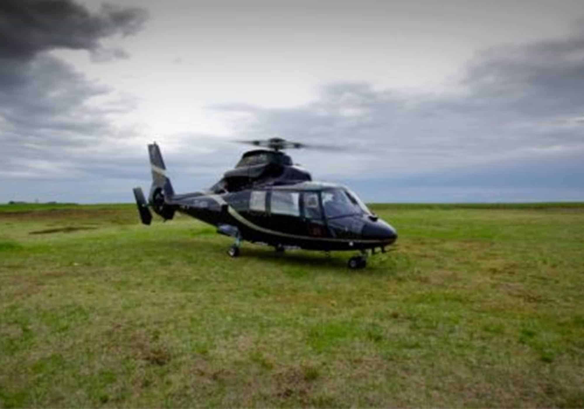 Helicopter parked on a grassy field in south Iceland.