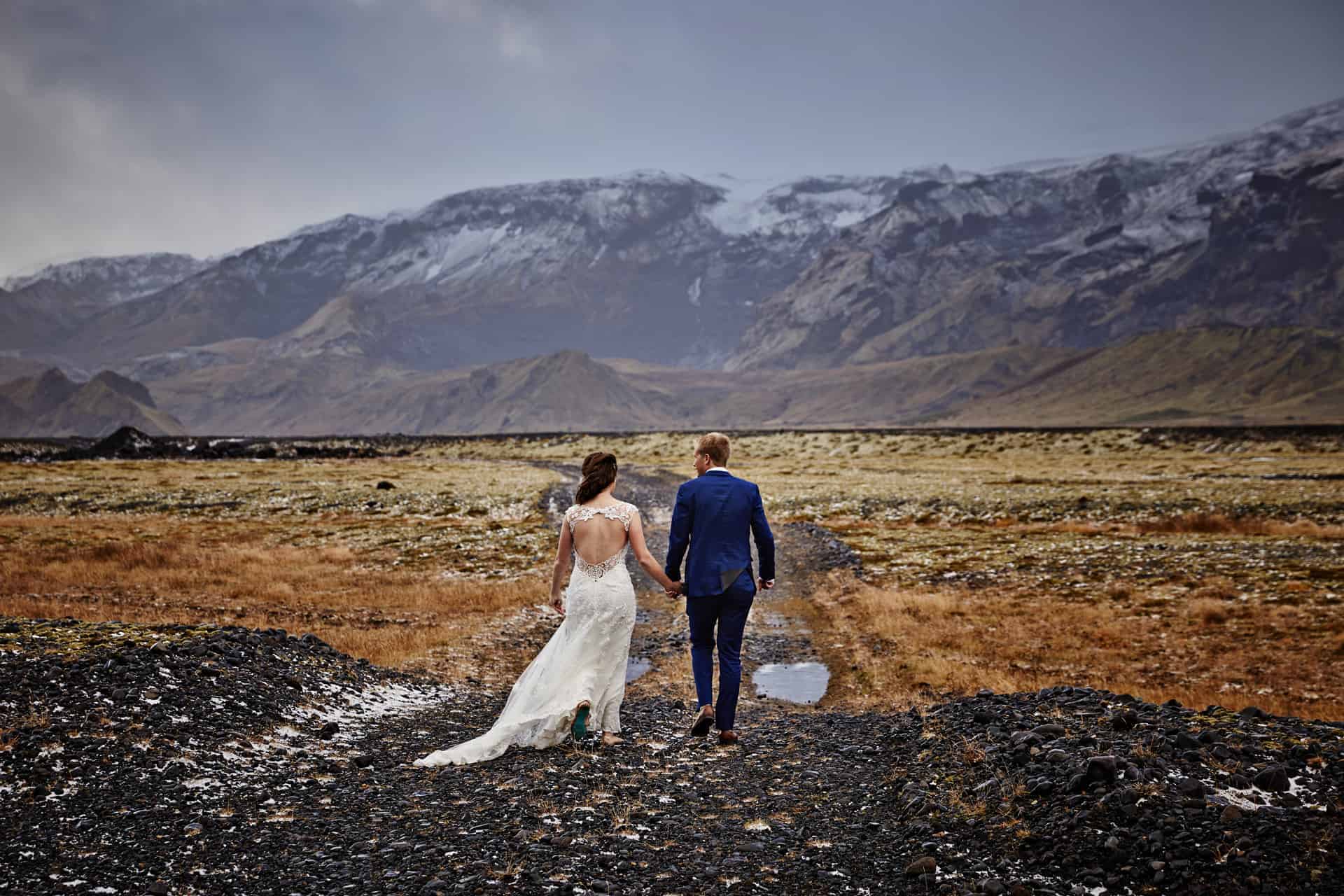 Wedding couple beside Icelandic glacier 