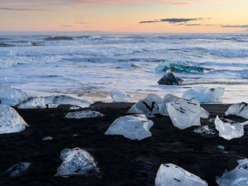 Glistening pieces of ice on the black sand Diamond beach in south Iceland.