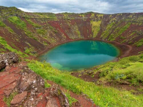 Kerið crater filled with blue green water in south Iceland.