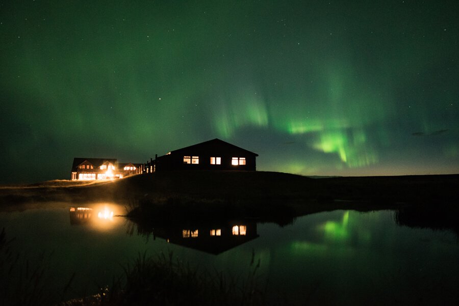 Green northern lights above Hotel Rangá luxury resort in south Iceland.