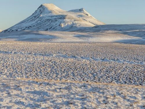 A snow-covered Þríhyrningur mountain in the valley of Fljótshlíð in south Iceland.
