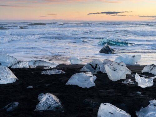 The black sand Diamond Beach covered in small fragments of icebergs that broke off from the nearby Breiðamerkurjökull glacier.