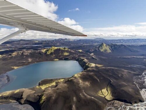 View of a glacier lake from inside a small airplane.