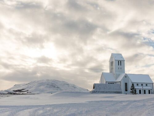 Skálholt church covered in white snow.