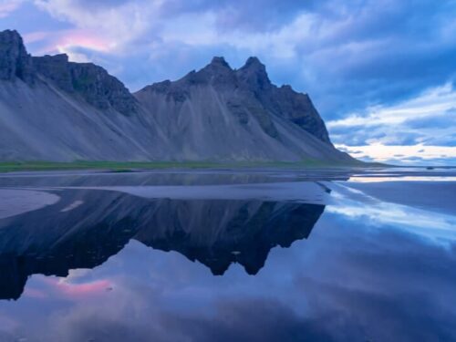 Vestrahorn mountain in south-east Iceland reflected in the sea.