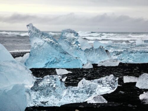 Pieces of glistening icebergs on black sands at Iceland's famous Diamond Beach.
