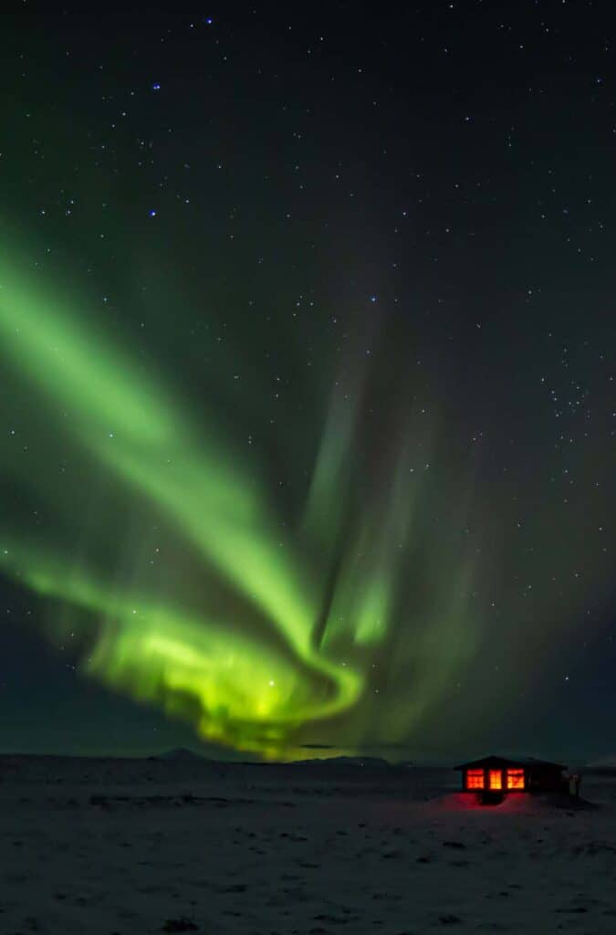 Green northern lights dance above the Hotel Rangá Observatory in south Iceland.