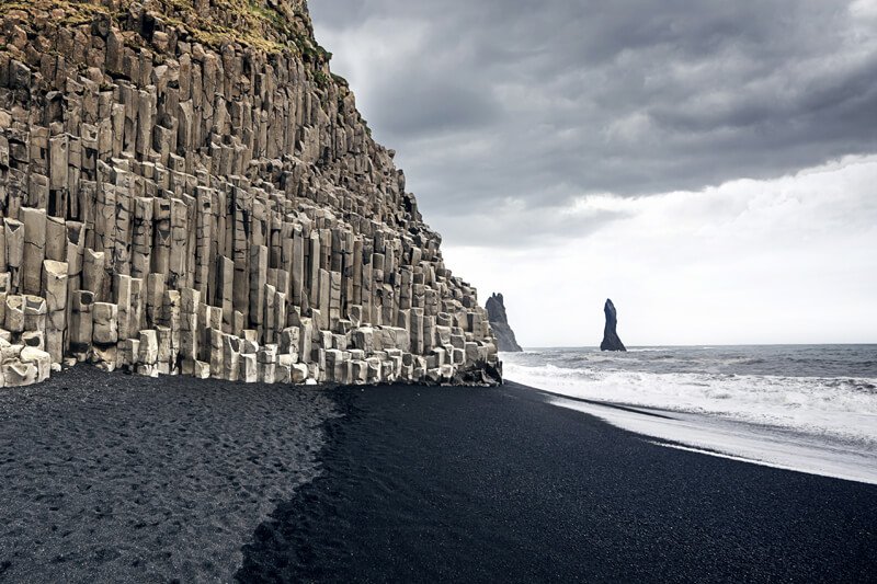 Columns of basalt at the black sand beach at Reynisfjara on the south coast of Iceland.