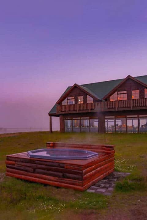 Exterior of Hotel Rangá in south Iceland with view of geothermal hot tubs.