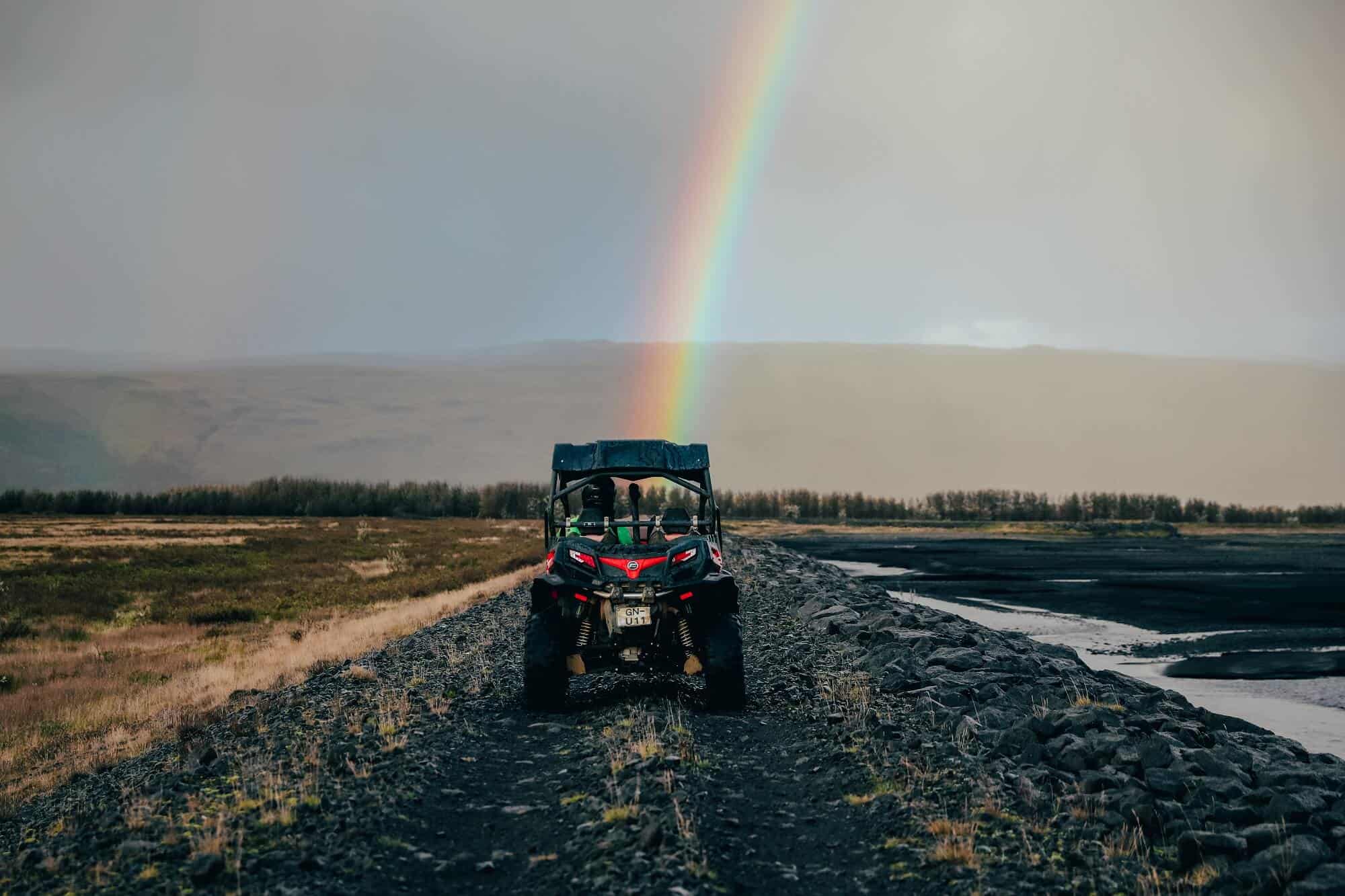A rainbow soars above a buggy in south Iceland.