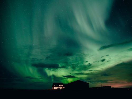 Green northern lights over Hotel Rangá in south Iceland.