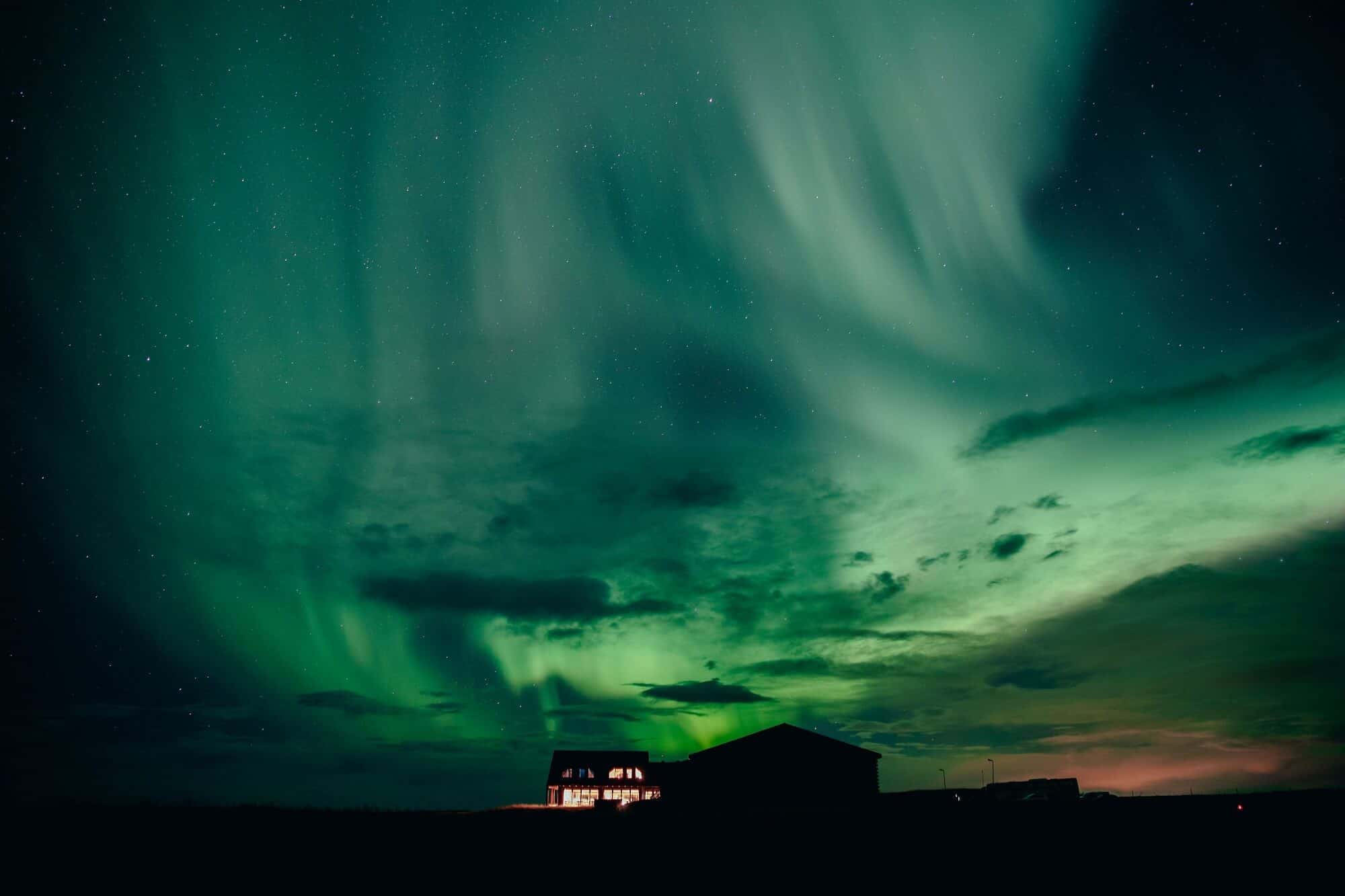 Green northern lights over Hotel Rangá in south Iceland.