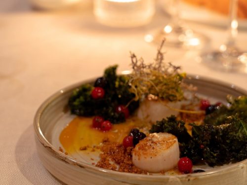 Pan-fried scallops with reindeer moss and pickled berries on Hotel Rangá's Wild Game Menu.