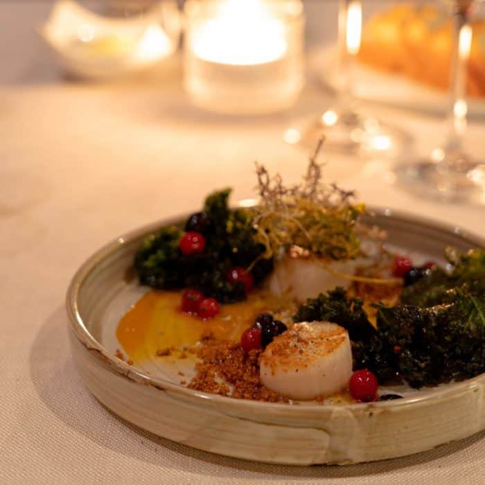 Pan-fried scallops with reindeer moss and pickled berries on Hotel Rangá's Wild Game Menu.