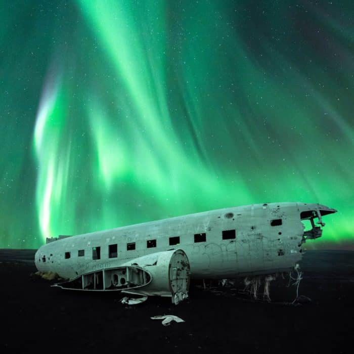 Green northern lights above the Sólheimasandur DC3 plane wreck.