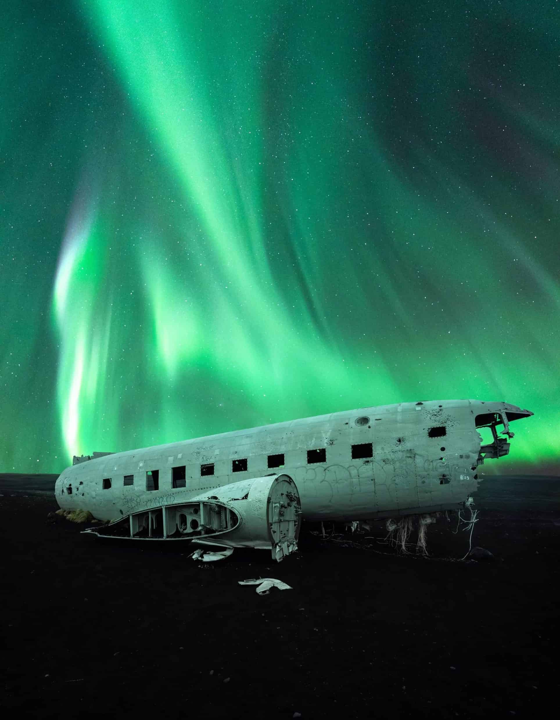 Green northern lights above the Sólheimasandur DC3 plane wreck.