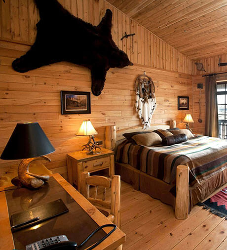 Hotel Rangá's North America Suite decorated with a bear skin, Native American artwork and an antler lamp.