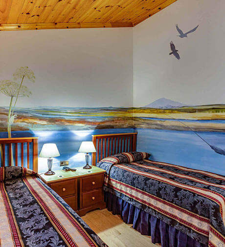 Hotel Rangá Standard room decorated with a mural of a fisherman in the Rangá River.