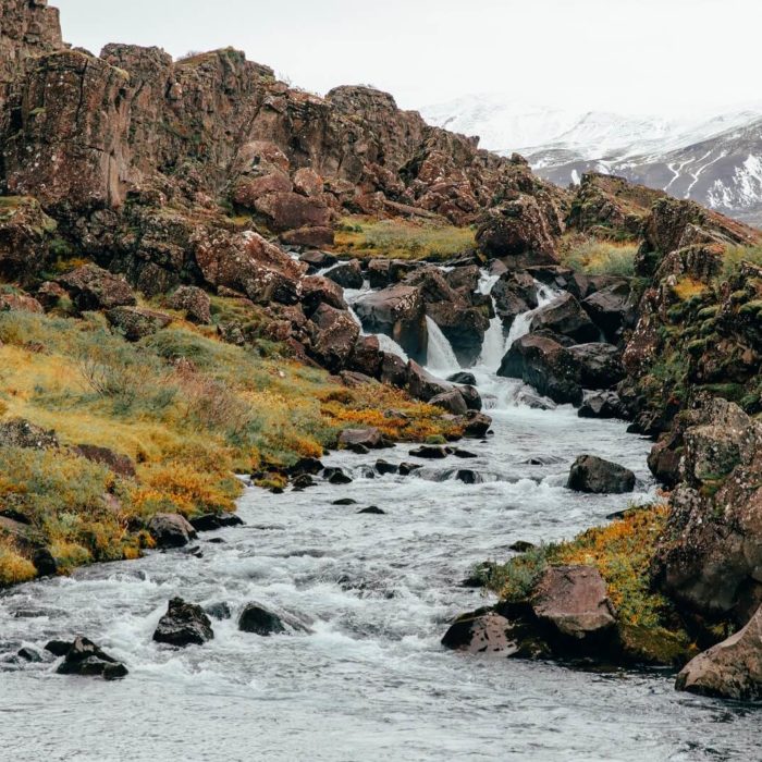 A stream tumbles over boulders in Þingvellir National Park in south Iceland.