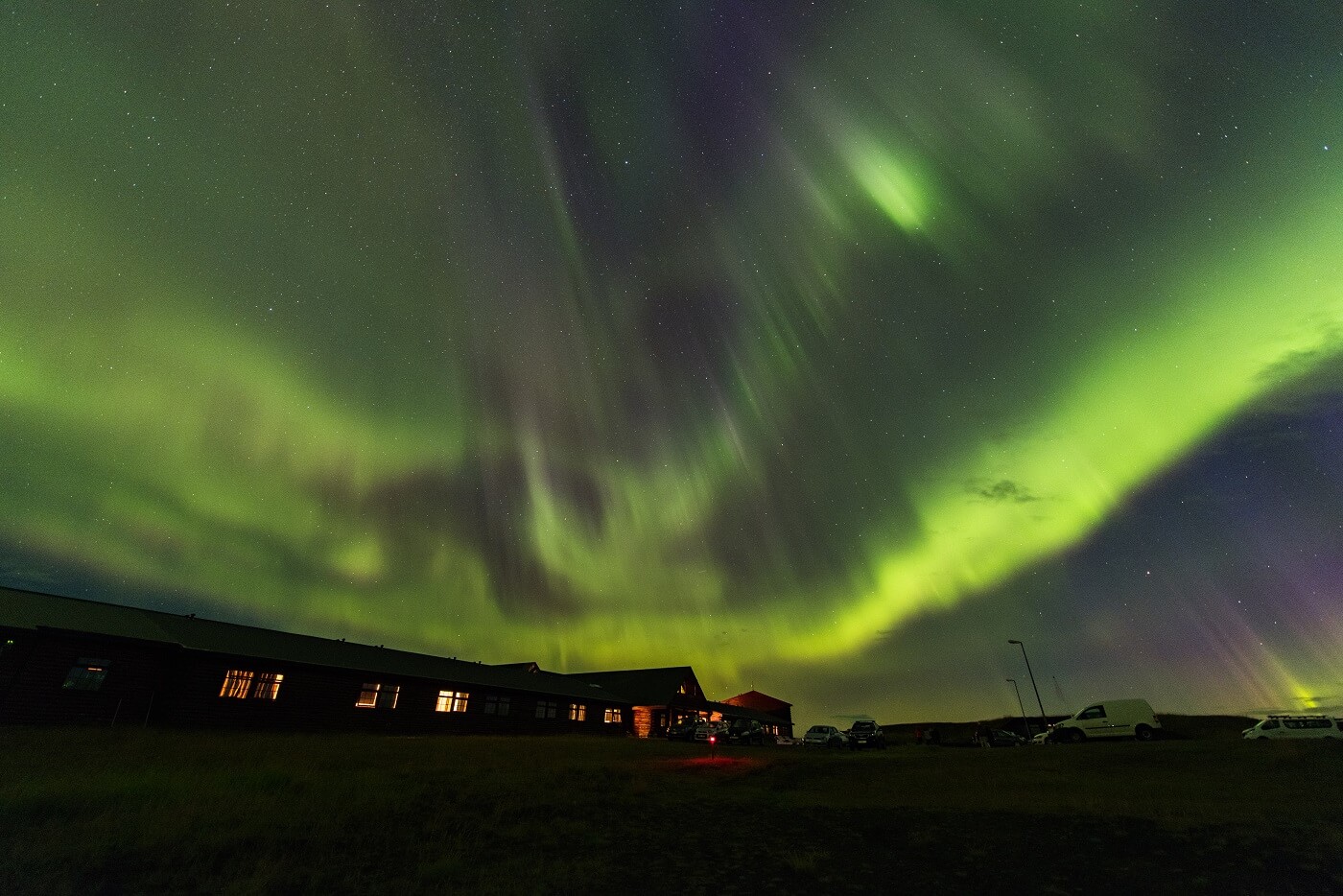 Green northern lights shimmer above Hotel Rangá luxury hotel in south Iceland.