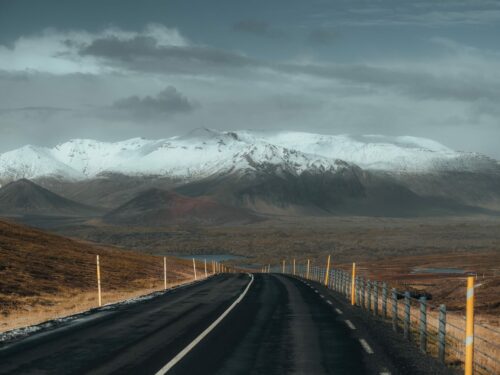 A paved country road in south Iceland with views of the glacier-volcano Eyjafjallajökull.