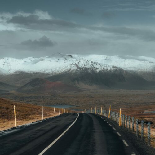 A paved country road in south Iceland with views of the glacier-volcano Eyjafjallajökull.