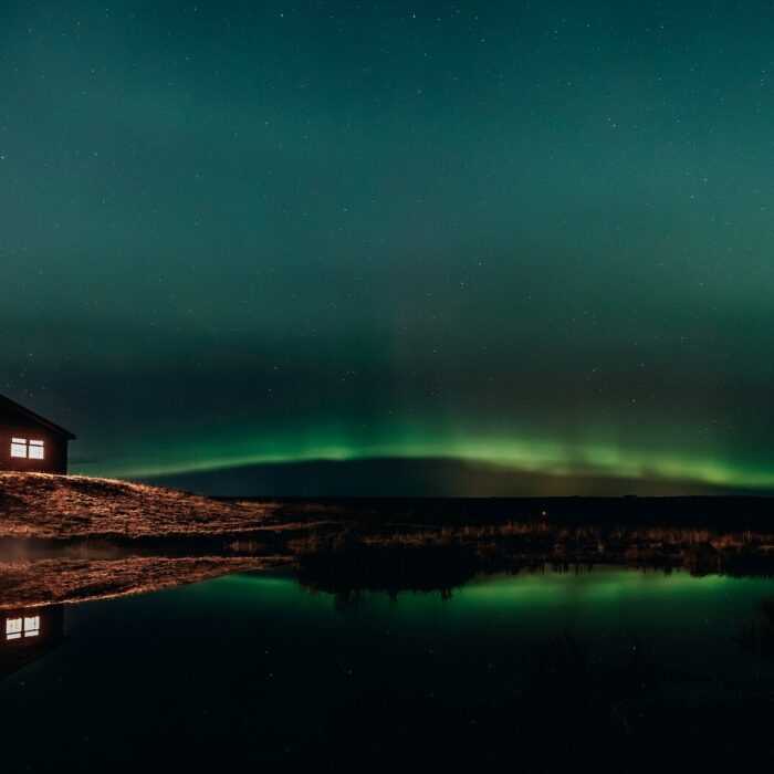 A band of northern lights stretches out beside Hotel Rangá in south Iceland.