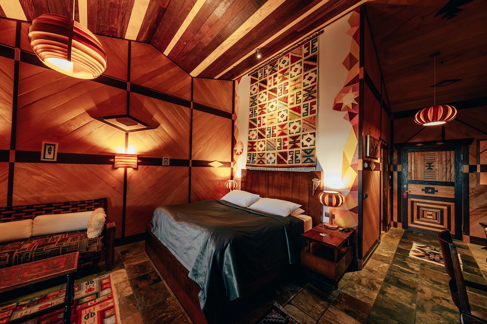 Hotel Rangá's South America Suite decorated with wooden panels, bright colors and authentic Peruvian furniture. 