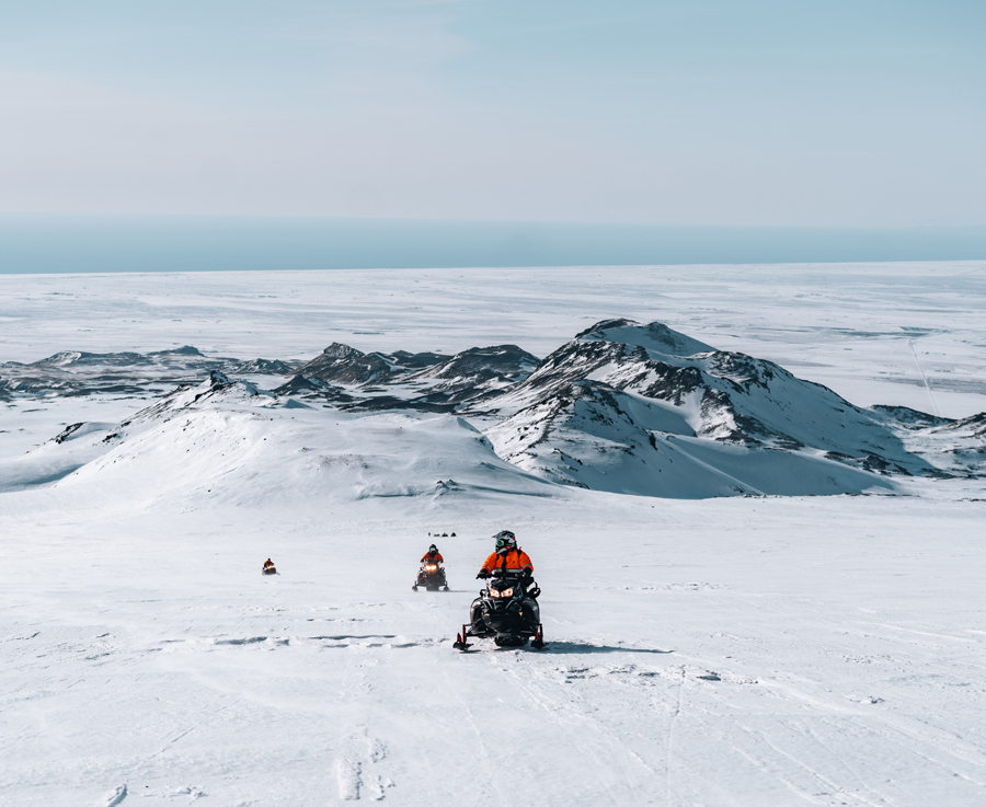 A group of people snowmobiling on the Eyjafjallajökull glacier in south Iceland.