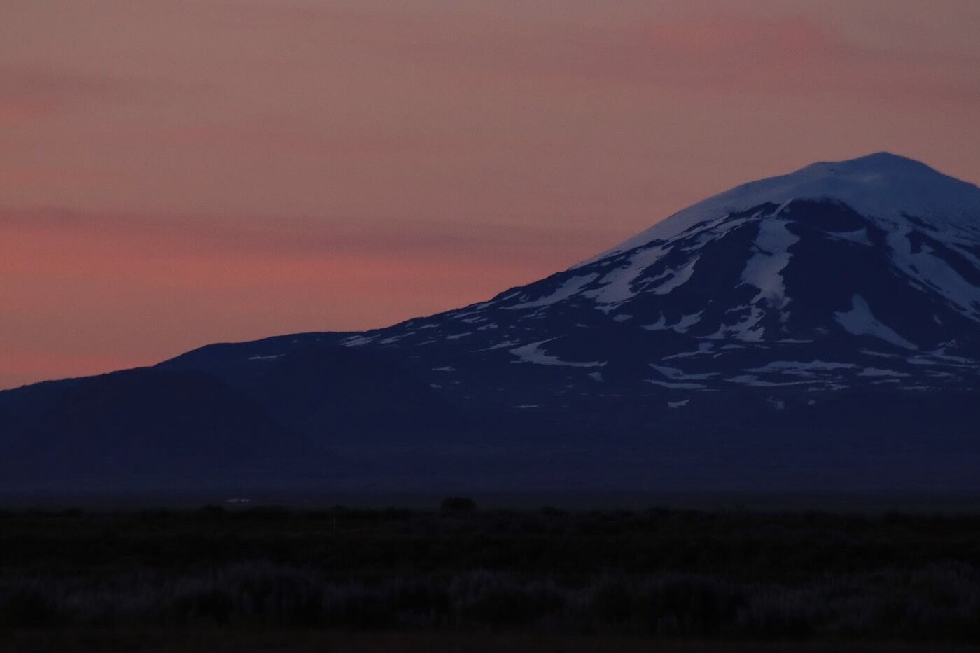 The snow-covered volcano, Hekla, underneath Iceland's midnight sun.