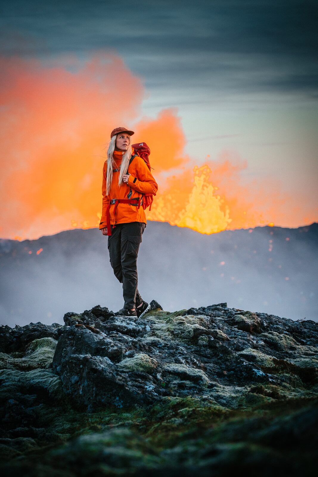 Photographer Ása Steinarsdóttir walking nearby the 2023 volcanic eruption at Litli Hrútur in Iceland.