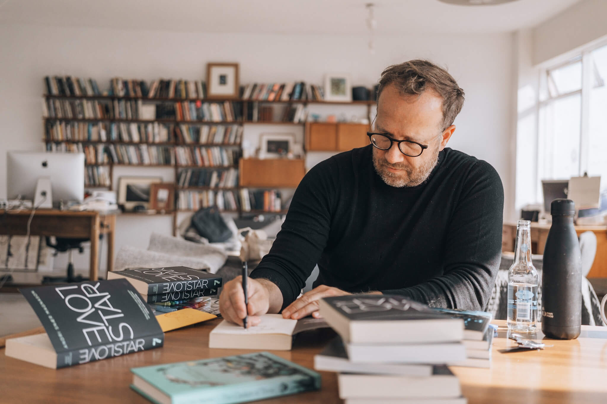 Andri Snær Magnason author signing a book for Hotel Rangá