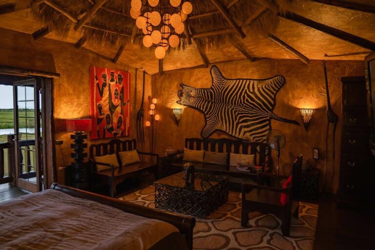 Hotel Rangá's Africa Master Suite decorated with a zebra skin, wooden furnishings, a painting of native Africans and more.