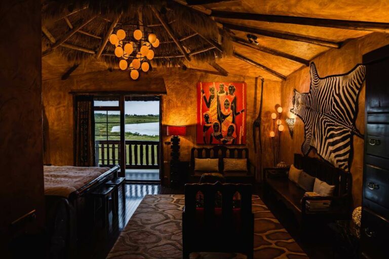 Hotel Rangá's Africa Suite decorated with a straw ceiling, zebra skin wall hanging, painting of Africans in traditional dress and wooden furniture.