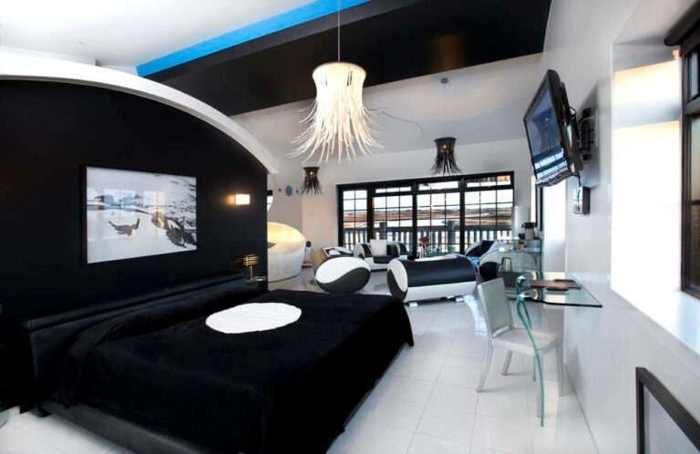 King bed and black and white furniture and decor in Hotel Rangá's Antarctica Master Suite.