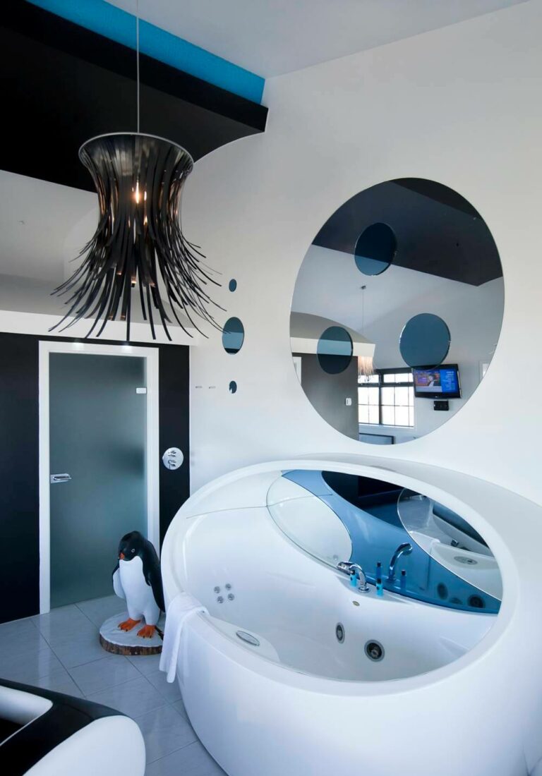 A penguin statue stands next to a futuristic soaking tub in Hotel Rangá's Antarctica Suite.