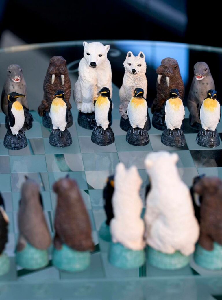 A glass chess set in Hotel Rangá's Antarctica Suite with animal pieces including penguins, seals, walruses and polar bears.
