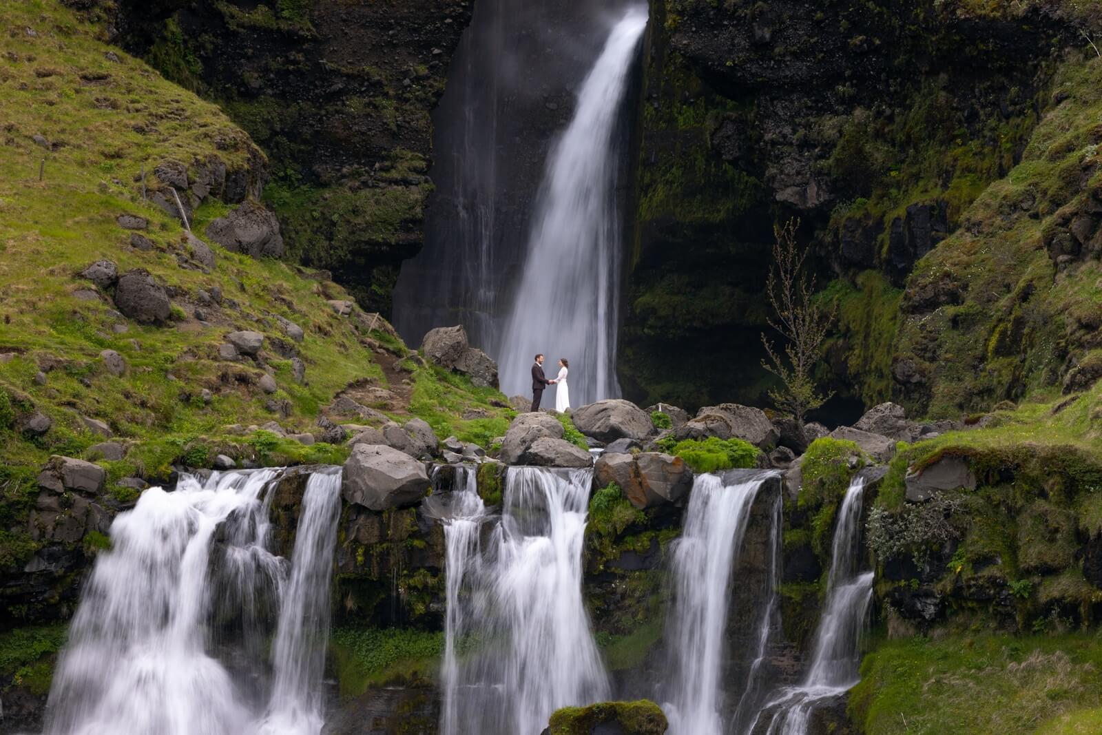 Wedding couple by Gluggafoss waterfall in South of Iceland
