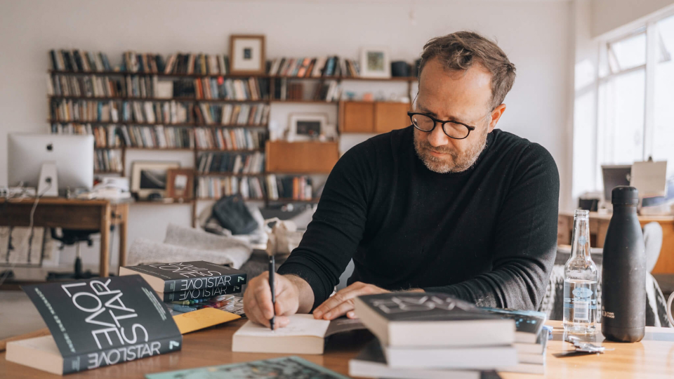 The author Andri Snær Magnason signs his book Love Star.