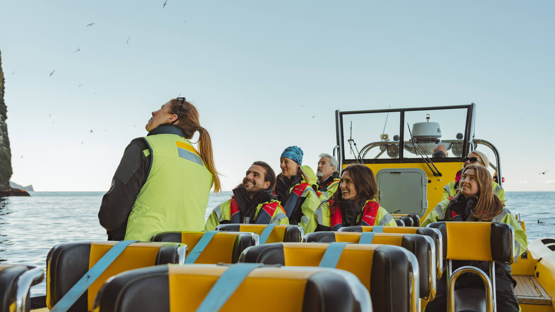 A group of people on a rib safari tour near the Westman Islands.