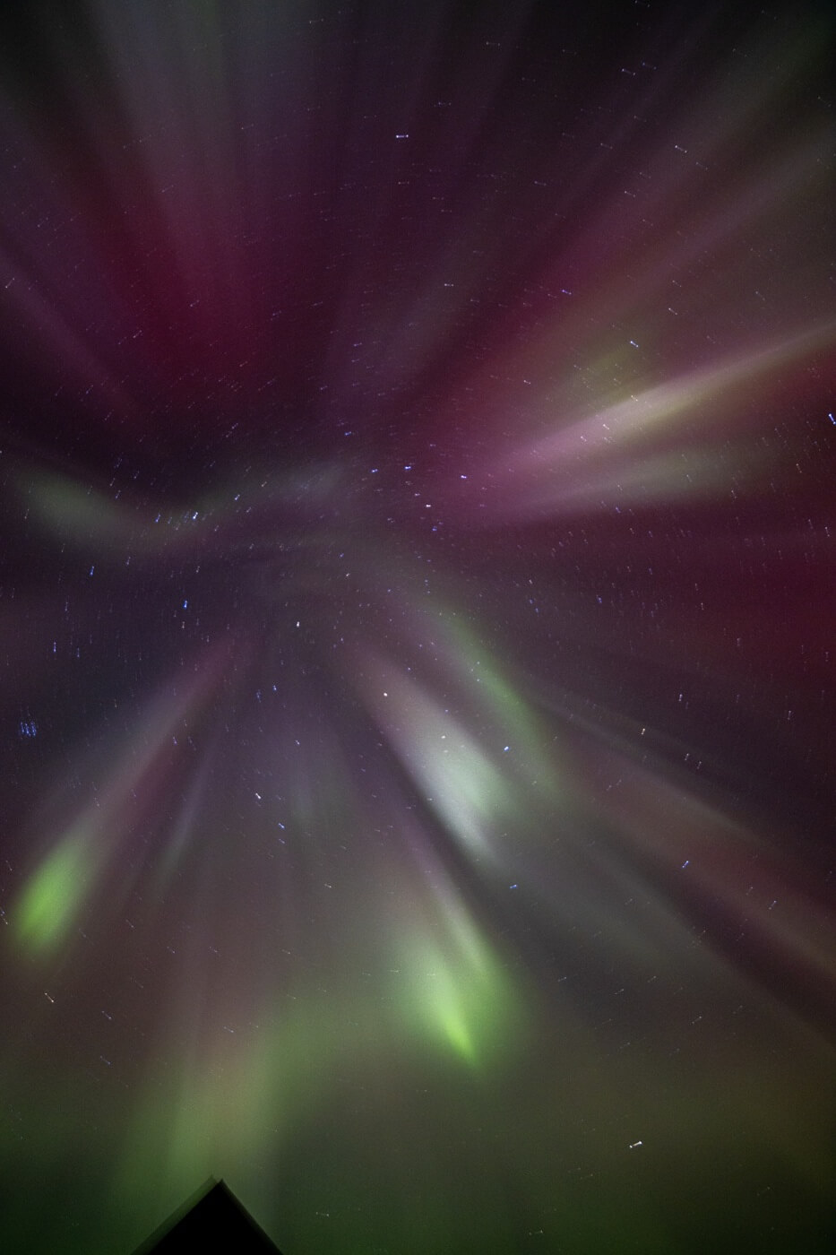 Green and purple northern lights dance above Hotel Rangá.