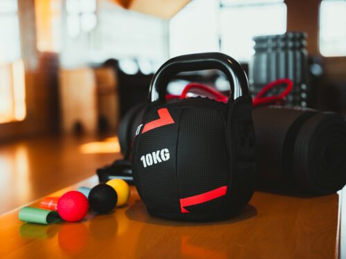 A kettlebell, massage balls, a resistance band, and a yoga mat in the upstairs lounge at Hotel Rangá as part of our Gym in A Bag.